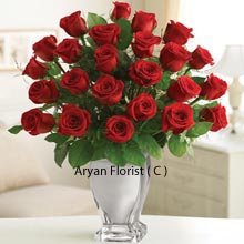 Like the open wings of the peacock, these beautiful and charming bunch of 18 deep red roses are presented with similar happiness. You may buy this bunch of red roses to celebrate any glorious day. Birthdays, anniversaries, sorry, first date, valentine's day, meeting with friends, and any other, this bunch always comes handy, without much thought. The very admirable glass vase appears like a crystal one and is surely a perfect match for these red roses.
