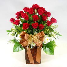 When planning to give flowers, roses are always on the top priority. With that in mind, we have created this beautiful bunch of 24 red roses and present to you in a lovely wooden vase. The wooden vase makes this bunch appear like they have just been bought from the woods. The ribbon that is transformed into a bow adds to the vigor and gives the whole bunch a contemporary feel. Further, these are decorated with the greens and other small contrasting flowers. Go for this without much ado!