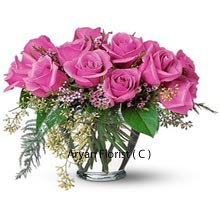 Filled with delicateness, this bunch of 12 pink roses will allow you to have an exquisite and playful day together. Order this special bunch for your love, if you need to impress her or congratulate her on any success story that she may have shared with you. This lovely bunch is available in a glass vase that is large and can be used for other purposes later. The season fillers are added to this to make this bunch all the more charming.