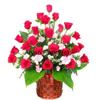 This extravagance will easily capture anyone's heart. A bunch of 24 red roses in a pretty cane basket, this piece of beauty is put together and enriched with fillers. Perfection of the expert florist unites with the beauty of red roses in a woven cane basket that adds the charm. Each flower is made to stand out while large green leaves drop gracefully around them. No hassles in carrying or displaying this bouquet that is carefully created choosing only the best.