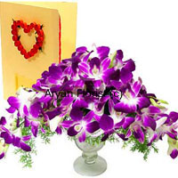 Imagine a bouquet of orchids at your doorstep. What an enchanting surprise! A bunch of purple orchids in a pretty vase along with a greeting card that holds your message, this combination is most suitable for those who stand apart, those with a classy taste. A selection of the best orchids – blooms and buds – this assemblage is embellished with green ferns and fillers. The stylish vase teams up well with the creative arrangement of the orchids. Perfectly oh! so impressive!