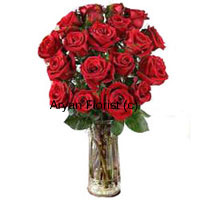 18 red roses hand gathered by expert florists are arranged in a classic clear glass vase. This bunch of roses is a classic expression of love. Ferns and green leaves are added to heighten the beauty of the roses. This arrangement is medium in size and easy to carry. The water in the vase keeps the roses fresh and sweet smelling for days. The perfect gift to shower your love over your loved one.