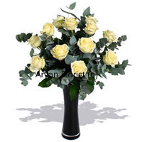 Yellow and bright, this bunch of 12 yellow roses brings sunshine along with it. Decorated with ferns and leaves in a glass vase, these yellow roses guarantee to brighten the occasion and the mood. Place near the windowsill or on the dinning table and it's sure to light up the world. The vase is specially selected to team up with the roses. This one makes for a great gift for those who love all things bright.