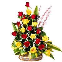 This basket of a dozen yellow and a dozen red roses in a creative conical design not only looks different, it is something that is specially created for those that stand out. The 12 red and 12 yellow roses with long stems have been selected by our expert florists for this structured bouquet. Add to the roses a bunch of seasonal fillers. The fancy round basket made of cane adds to the eccentric look. This piece makes for a great present for professional or personal occasions.