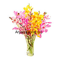 In vibrant shades of yellow, pink and red, a bounty of colourful orchids in a vase is sure to brighten up everyone's day. These exotic blooms are arranged in a simple and elegant fashion. The simple vase heightens the majestic appearance of the orchids. Fragrant and beautiful, a collection of orchids in different colours is certain to stand out even in the biggest gardens. This one makes for a perfect present, for friends and professional associates alike.