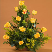 At once bright and attractive, this bunch of 12 yellow roses is sure to brighten up your friend's day. Creatively designed along with fillers and green leaves, each of the roses is placed in such a manner that it's brightness and beauty is easily highlighted. Surprise your friend by sending this to their home or office on occasions such as friendships day, a new job, a new house or just to let them know you're there.