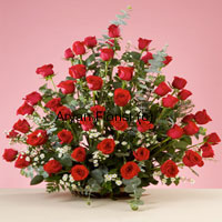 This gorgeous basket of 50 red roses is sure to have a mesmerizing effect on whoever sees it. As vivacious as a fresh rose plant, this bouquet is arranged with fresh leaves, fillers and ferns that add to the volume and beauty of the arrangement. The fresh rose flowers spread the sweetest fragrance. The cane basket almost gets hidden with the spread of the long stem roses and fillers, adding to the look. Easy to carry and display on tabletops, this one is a preferred choice for almost all occasions.