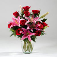 Lilies and red roses along with the seasonal fillers and a lovely looking vase will be all yours if you get this! So ask your friends and family to surprise you with this elegant looking flowers and if you wish you may gift it to yourself too!! You may keep the flowers and your mum will preserve the indelible vase forever! Place your order now and bring a smile to your family, friends or any you love.