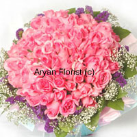 Think grand! Think big! This huge bunch is created out of 100 pink roses. A round arrangement of pink roses in full bloom is surrounded by seasonal fillers of different colours and green leaves. The look is finished with a wrapping paper around the flowers and a ribbon. Express your feelings of love and happiness with this bouquet. This one is sure to impress!