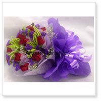 Bunch Of 12 Red Roses Beautifully Wrapped in Purple Paper With Seasonal Fillers