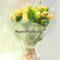 This is the perfect yellow to brighten anyone's day! This bunch of 12 yellow roses is crafted delicately into a simple bouquet yet one that looks exquisite. The fresh green flowers and fillers add volume to the bouquet. Translucent wrapping paper around the bouquet adds style, as does the yellow satin bow. This makes for a perfect welcome gift, get well soon wish and thank you expression.