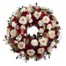This wreath is created with beautiful blooms of various kinds. Fresh and handpicked, they are delicately placed to form a pleasant and lovely testament to the circle of life. Evoking fond memories and goodness of the deceased, this arrangement is a lovely offering.
