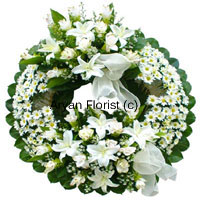 This wreath created with soft white flowers and green leaves is a lovely tribute to a lovely soul. Evoking fond memories of life, it is an expression of cherished emotions. Send your deepest condolences with this arrangement of sensitive white blooms.