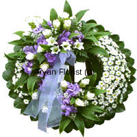 This wreath is designed with different flowers in white, cream and blue. It is a beautiful and unusual tribute to the precious life, which will be remembered forever. The flowers are handpicked and each flower is delicately placed. Embellishments of white ribbons add to the serene look.