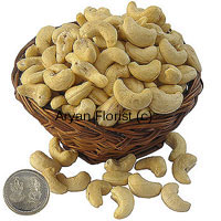 Send this basket of 250 grams plain cashew nuts and a silver Lakshmi Ganesh coin to your friends and family to celebrate festive occasions. Best quality cashew nuts are neatly put in the basket and wrapped creatively. Adding to it the auspicious silver coin and it makes for a perfect festive gift.