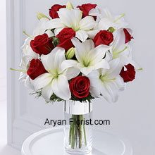 The combination of red roses with white Oriental lilies is a surreal one, that is indeed a harbinger of Christ! So, let's welcome the season of festivities, mirth, joy, and happiness with this lovely arrangement of flowers put together in a crystal clear cylindrical vase that is wrapped in silver ribbon to elevate the feeling of these magical days. (Please Note That We Reserve the Right to Substitute any Product with a Suitable Product of Equal Value in Case of Non-Availability of a Certain Product)