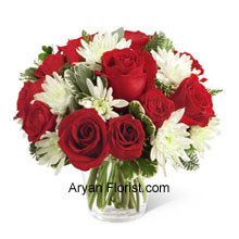 This Bouquet is an endearing way to extend warm wishes for this holiday season and display affection and admiration. The Rich red roses and spray roses that are arranged with white chrysanthemums, assorted Christmas greens, and eucalyptus. These are placed very beautifully in a round clear glass vase that acts as the foreground for these flowers. This superb arrangement spreads friendship and love and creates the festive spirit. So please your friends with this and celebrate together. (Please Note That We Reserve the Right to Substitute any Product with a Suitable Product of Equal Value in Case of Non-Availability of a Certain Product)