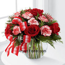 The waft of the season is symbolized through the fragrance of the Red Roses and the peppermint carnations. This brings the nostalgia of the previous year and allows one to indulge more than the last year. This lovely arrangement comes in a glass bubble bowl that is decorated with red and white ribbon to elevate the appearance of the entire arrangement. So place an order for this and welcome the season with grace. (Please Note That We Reserve the Right to Substitute any Product with a Suitable Product of Equal Value in Case of Non-Availability of a Certain Product)