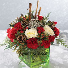 This affluent looking bouquet is indicative of your royal choice. This is indeed a breathtaking bouquet and has white roses, red carnations and Christmas greens that are absolutely perfect to wish your loved ones. The cinnamon sticks and pine cones are also a part of this lavish bouquet and spread beautiful aroma, apart from enhancing the beauty of the arrangement of flowers. All this comes in a uniquely shaped and tenacious glass cube bowl that holds this bunch of luscious flowers with ease. (Please Note That We Reserve the Right to Substitute any Product with a Suitable Product of Equal Value in Case of Non-Availability of a Certain Product)