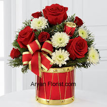 The most contemporary and popular combination of red and white is presented to you in this lovely arrangement of Rich red roses and spray roses along with white chrysanthemums. This arrangement is further highlighted and made more harmonious by the addition of lush holiday greens. The drum shaped vase with a golden ribbon on the edges adds to the dazzle to this already attractive collection. So celebrate this season with this contemporary mélange of red and white that are complemented with greens. (Please Note That We Reserve the Right to Substitute any Product with a Suitable Product of Equal Value in Case of Non-Availability of a Certain Product)