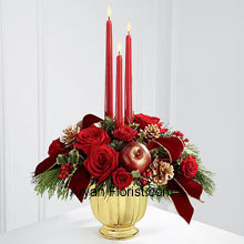 The feasts of light come true with the 3 red colored candles that are perfectly placed among the very pretty arrangement of Bright red roses and spray roses, arranged in a sparkling gold vase. This arrangement is further decorated with variegated holly and assorted holiday greens, artificial apples, gold pine cones and gold-edged burgundy ribbon that magnifies the essence of the festival and brings out the true spirit of celebrating Christmas. Enjoy your Christmas holidays with this sparkling arrangement, especially when you receive this from someone. (Please Note That We Reserve the Right to Substitute any Product with a Suitable Product of Equal Value in Case of Non-Availability of a Certain Product)